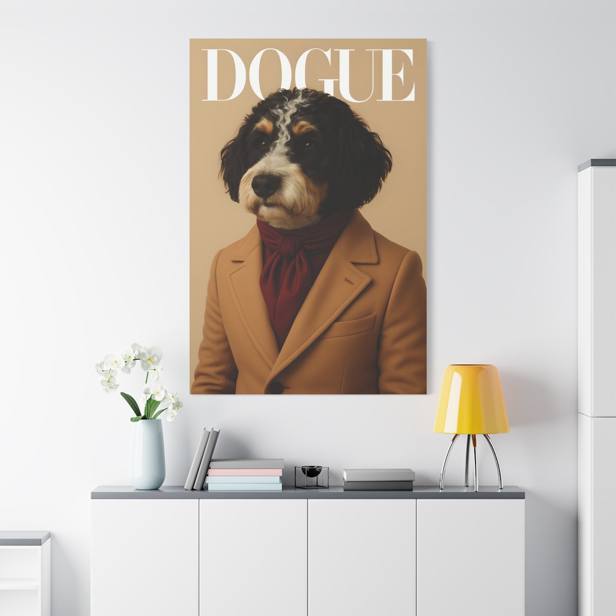Poster of a dog in a suit with 'DOGUE' text on a wall above a white cabinet.
