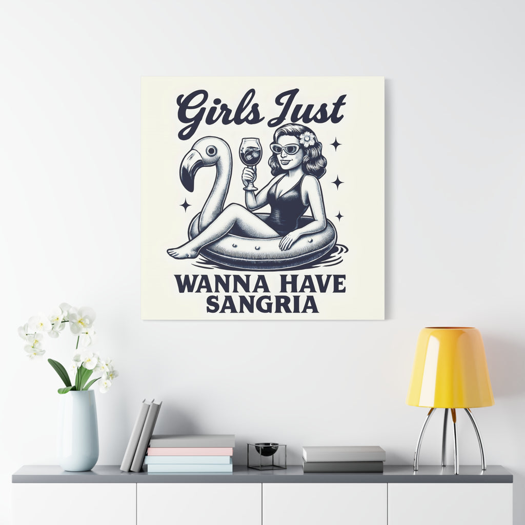 Canvas print with a design of a woman on an inflatable flamingo, holding a glass of wine, with text 'Girls Just Wanna Have Sangria' on a white wall above a shelf.